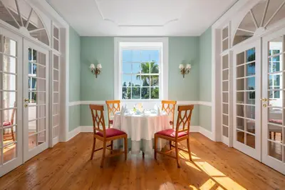 a dining room with a table and chairs and a window at Quinta Jardins do Lago in Funchal