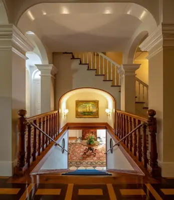 a staircase in a house with a painting on the wall at Quinta Jardins do Lago in Funchal