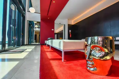 a living room with a couch and four paintings at Quinta Mirabela - Design Hotel in Funchal