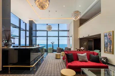 a living room with a red couch and a table at Royal Savoy - Ocean Resort - Savoy Signature in Funchal