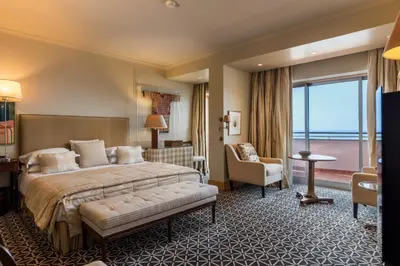 a hotel room with a bed and a large window at Royal Savoy - Ocean Resort - Savoy Signature in Funchal