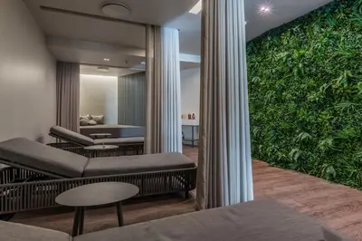 a living room with a large green wall at TUI Blue Gardens - Adults-only - Savoy Signature in Funchal