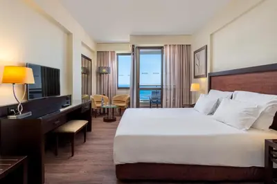 a hotel room with a large bed and a desk at TUI Blue Gardens - Adults-only - Savoy Signature in Funchal