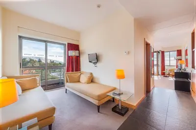 a living room with a couch and a large window at TUI Blue Gardens - Adults-only - Savoy Signature in Funchal