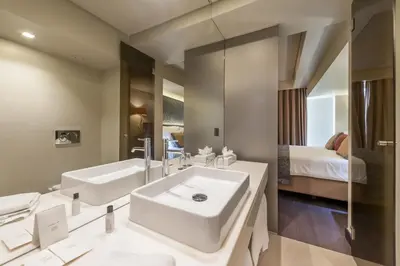 a large bathroom with a sink and a bed at TUI Blue Gardens - Adults-only - Savoy Signature in Funchal