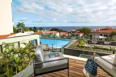 a balcony with a view of a swimming pool at TUI Blue Gardens - Adults-only - Savoy Signature in Funchal