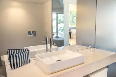 a bathroom with a white sink and a mirror at TUI Blue Gardens - Adults-only - Savoy Signature in Funchal