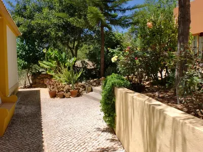 a garden with potted plants and a stone walkway at Quinta dos Caracois in Lagos
