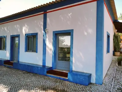 a white and blue house with a blue door at Quinta dos Caracois in Lagos