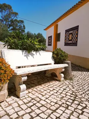 a white bench sitting in front of a building at Quinta dos Caracois in Lagos