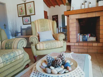 a living room with two chairs and a fireplace at Quinta dos Caracois in Lagos