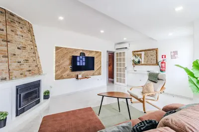 a living room with a couch and a fireplace at Casa da Avó in Espiche
