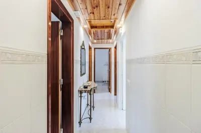 a hallway with white walls and a wooden ceiling at Casa da Avó in Espiche