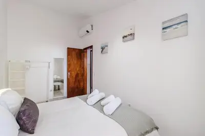 a bedroom with a white bed with two pillows at Casa da Avó in Espiche