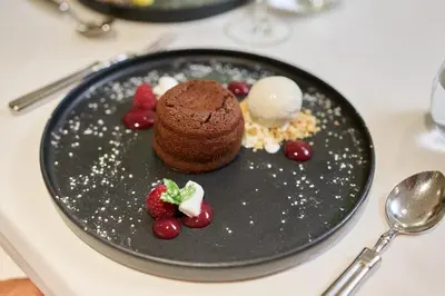 a plate with a chocolate dessert on a table at Quintinha Sao Joao Hotel & Spa in Funchal
