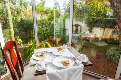 a table with plates of food on top of a window at Quintinha Sao Joao Hotel & Spa in Funchal