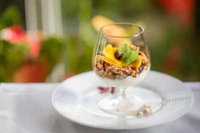 a wine glass with food in it on a plate at Quintinha Sao Joao Hotel & Spa in Funchal