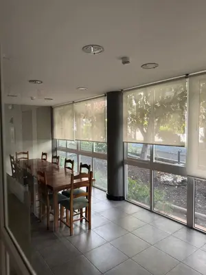 a living room with a table and some chairs at Monte Verde in Funchal