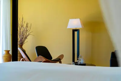 a room with two chairs and a table with a lamp at Vila Valverde Design Country Hotel in Luz