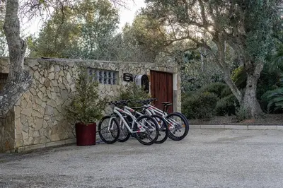 a group of bikes parked next to a stone wall at Vila Valverde Design Country Hotel in Luz