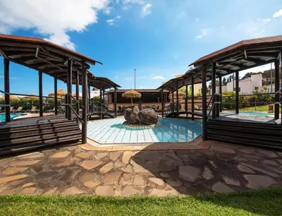 a resort with a pool and a pavilion at Dom Pedro Garajau in Caniço