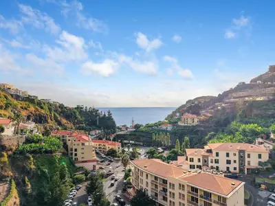 an aerial view of a town on a hill with the ocean at Sunny Ponta 