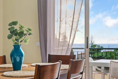 a vase sitting on a table with a view of a balcony at Sunny Ponta 