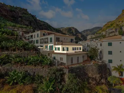 a group of houses on a hill with mountains at Sunny Ponta 