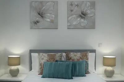 a bedroom with a bed with two lamps at ANGEL´S SUNSET in Estreito da Calheta
