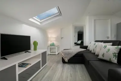 a living room with a couch and a flat screen tv at ANGEL´S SUNSET in Estreito da Calheta