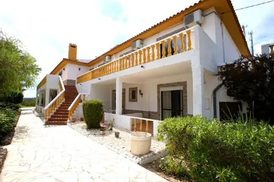 a large white house with a staircase in front of it at Belo Horizonte in Luz