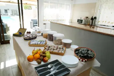 a table with fruits and food on it in a kitchen at Belo Horizonte in Luz