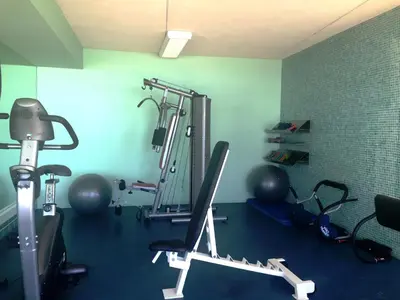 a room with a gym with a treadmill and weights at Madeira Regency Cliff - Adults Only in Funchal