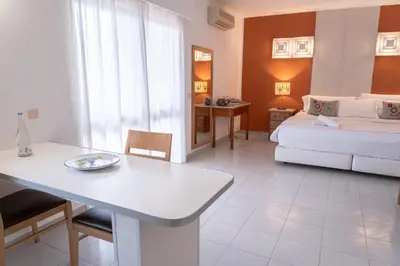 a living room with a bed and a white table at Villa Mar Azul in Lagos
