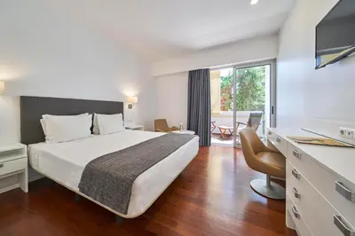 a hotel room with a bed and a large window at Hotel Porto Santo & Spa in Porto Santo