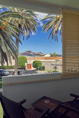 a window with a view of a palm tree at Hotel Porto Santo & Spa in Porto Santo