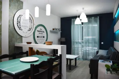 a dining room with a green table and chairs at Porto Santo Apartment in Porto Santo