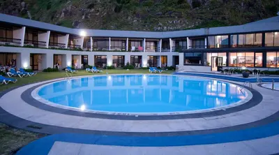 a large living room with a pool table and chairs at Estalagem do Mar in São Vicente