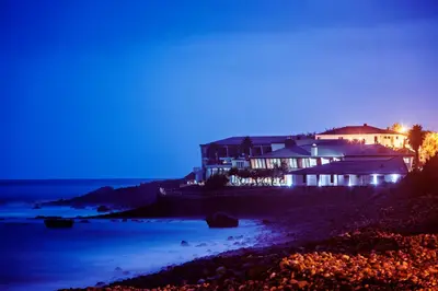 a hotel room with a bed and a large window at Estalagem do Mar in São Vicente