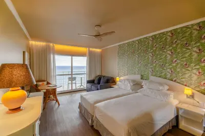 a hotel room with a bed and a view of the ocean at Pestana Ocean Bay Resort in Funchal