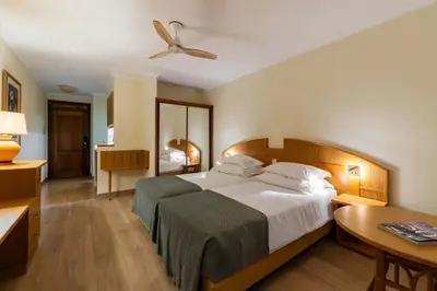 a bedroom with a bed and a ceiling fan at Pestana Ocean Bay Resort in Funchal