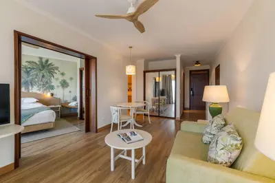 a living room with a couch and a bed at Pestana Ocean Bay Resort in Funchal