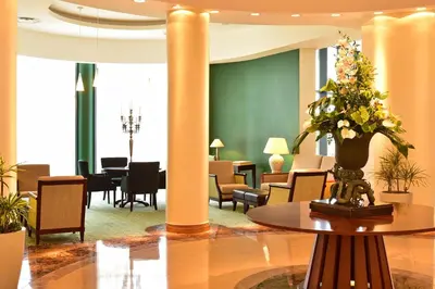 a lobby with a table with a vase of flowers at Pestana Grand Ocean Resort Hotel in Funchal