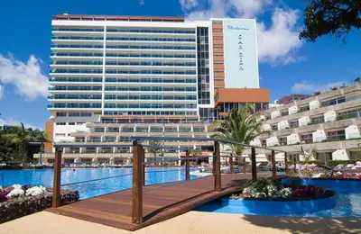 a hotel on the shore of a body of water at Pestana Carlton Madeira Ocean Resort Hotel in Funchal