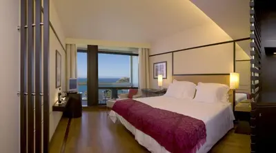 a hotel room with a large bed and a large window at Pestana Casino Park Hotel & Casino in Funchal