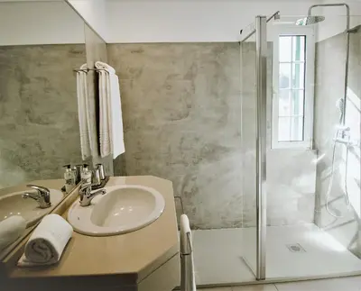 a bathroom with a sink and a shower at Solar da Bica in São Vicente