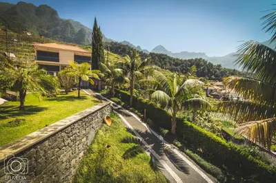 a dining room with wooden tables and chairs at Solar da Bica in São Vicente