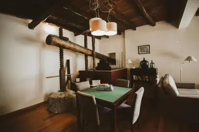 a living room with red chairs and a wooden ceiling at Solar da Bica in São Vicente