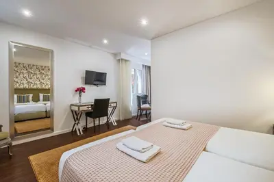 a hotel room with a bed and a table with a desk at Quinta da Tia Briosa by Homie in Ponta do Sol