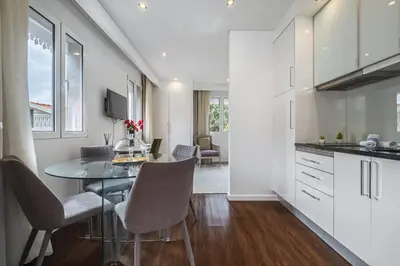 a kitchen and dining room with a table and chairs at Quinta da Tia Briosa by Homie in Ponta do Sol